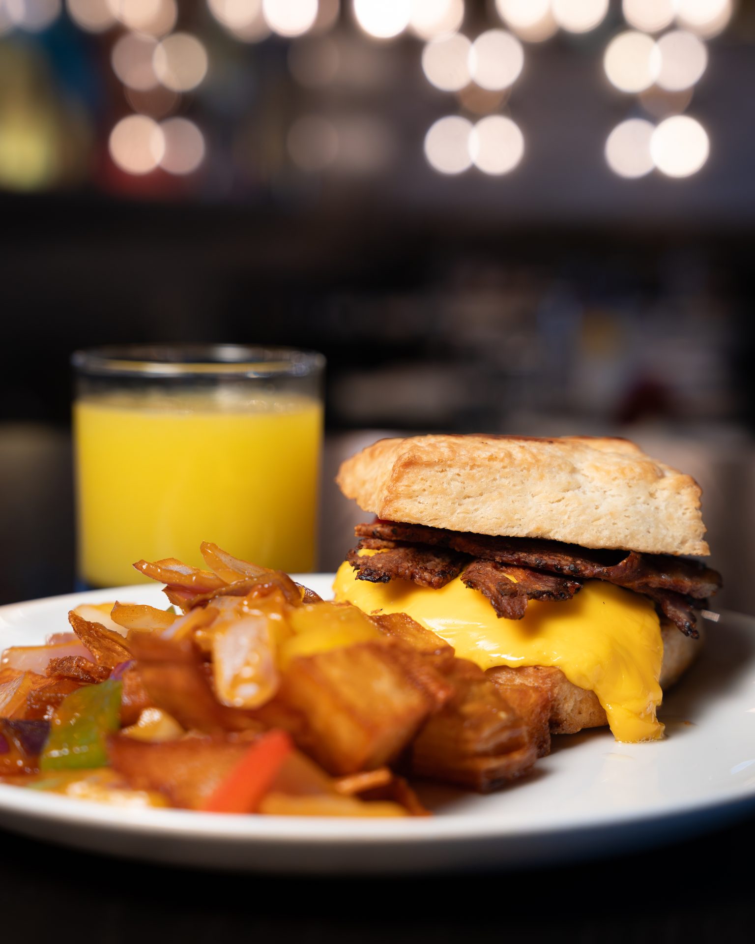 Breakfast sandwich with potatoes and orange juice