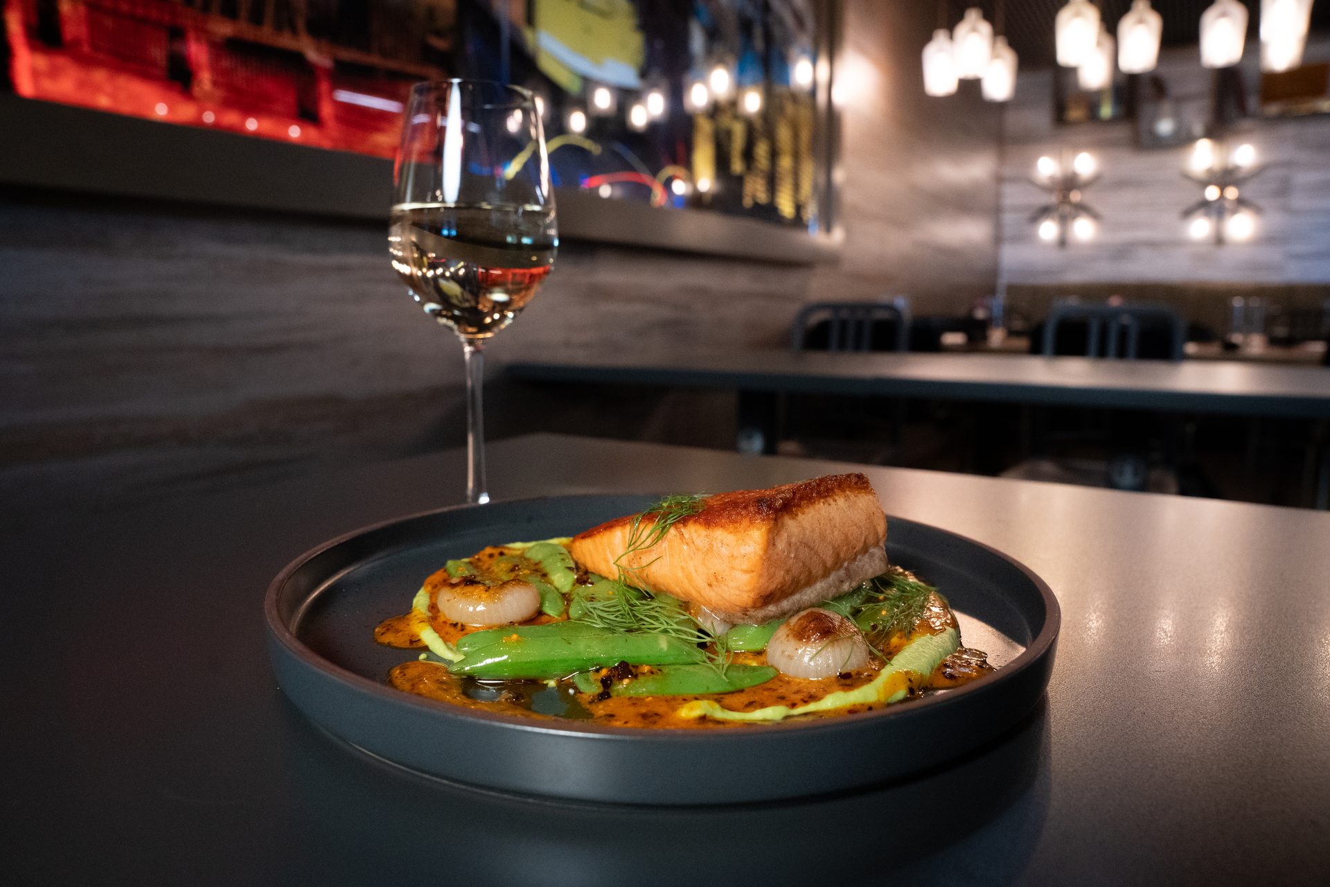 Seared salmon with snap peas and a glass of white wine